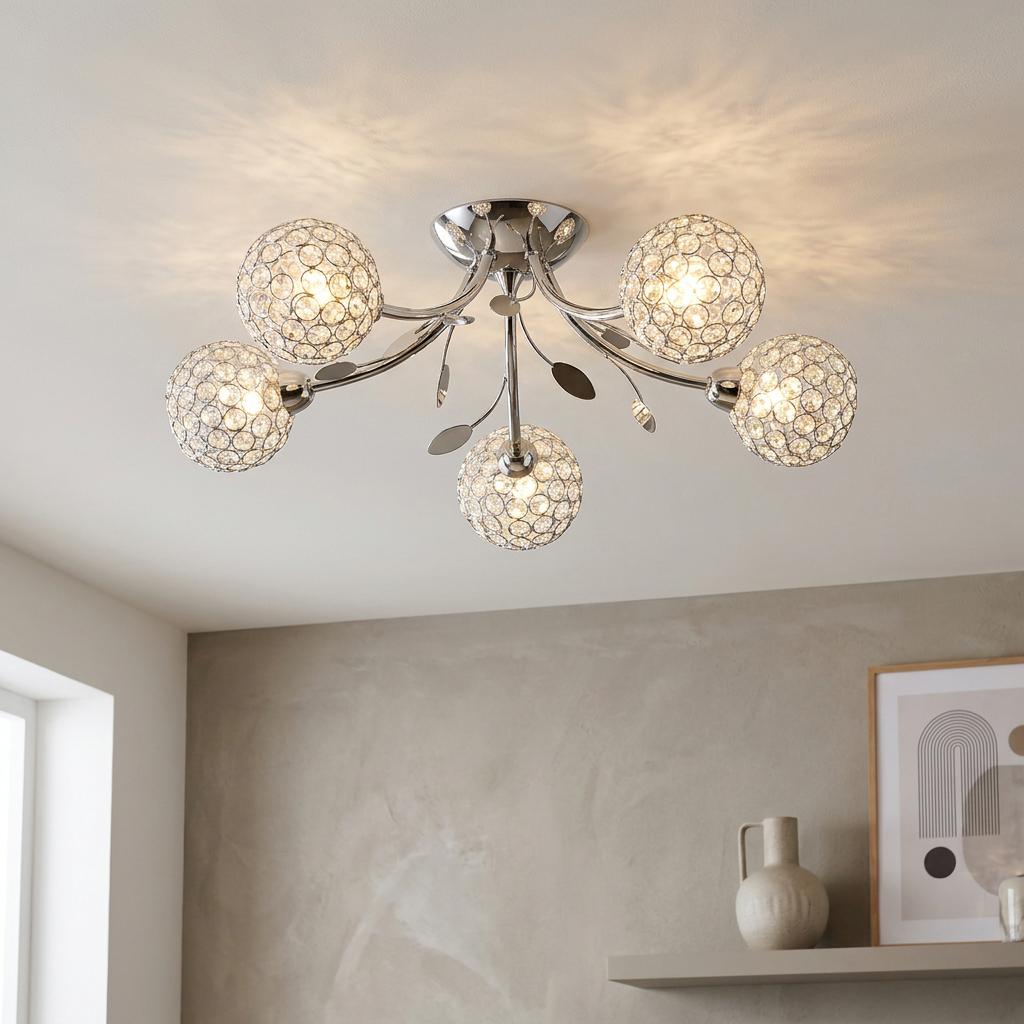 Bellis II 5-light semi-flush chrome ceiling light with crystal glass shades casting warm light in a modern room.
