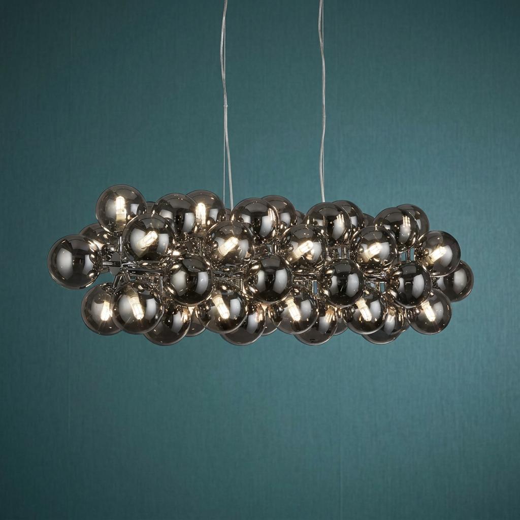 Berry 25 light chrome ceiling pendant with smoked glass spheres clustered against a dark teal wall.