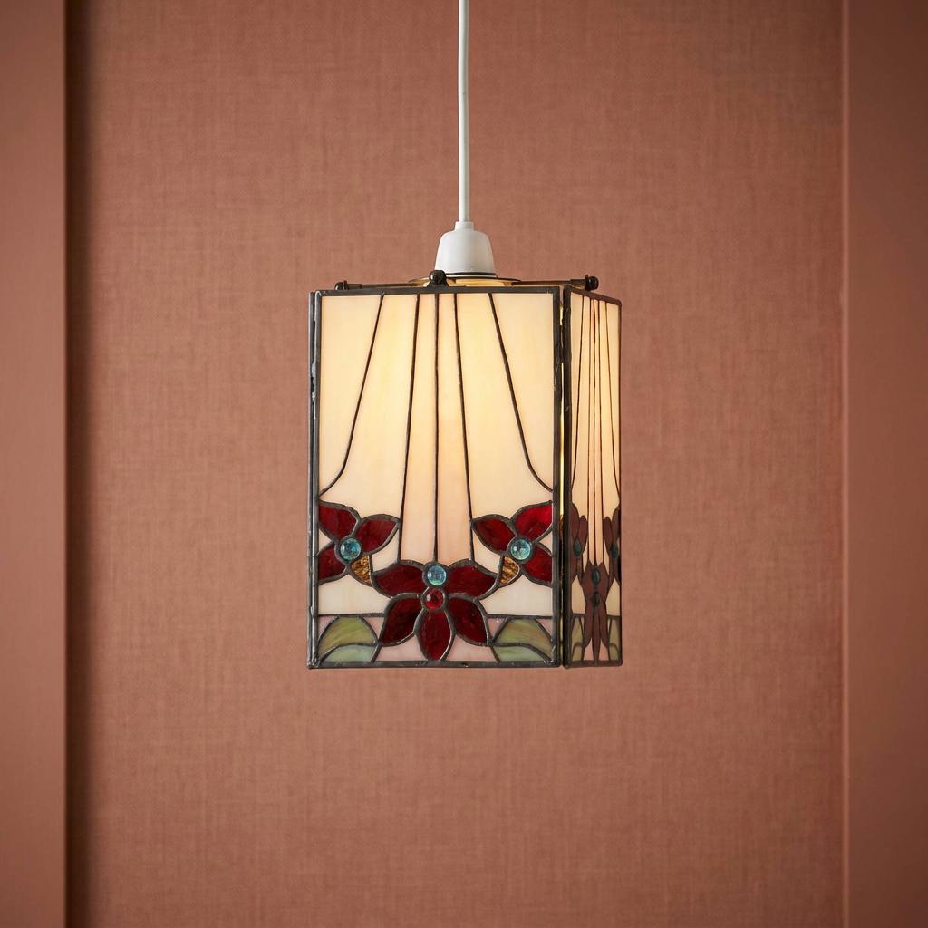 Camillo Red Tiffany easy fit lamp shade featuring red stained glass flowers hanging against a warm textured wall.