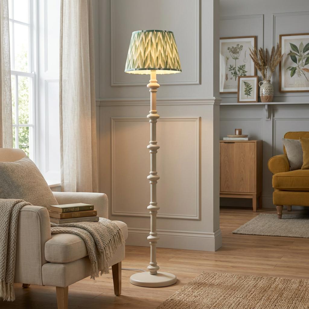 White Carnaby floor lamp with a green zigzag shade positioned in a neutrally decorated, cozy living room.