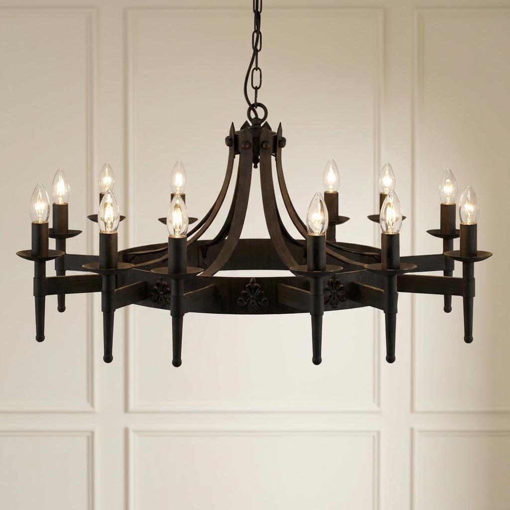 12-light black wrought iron cartwheel chandelier with candle-style bulbs and decorative fleur-de-lis accents.