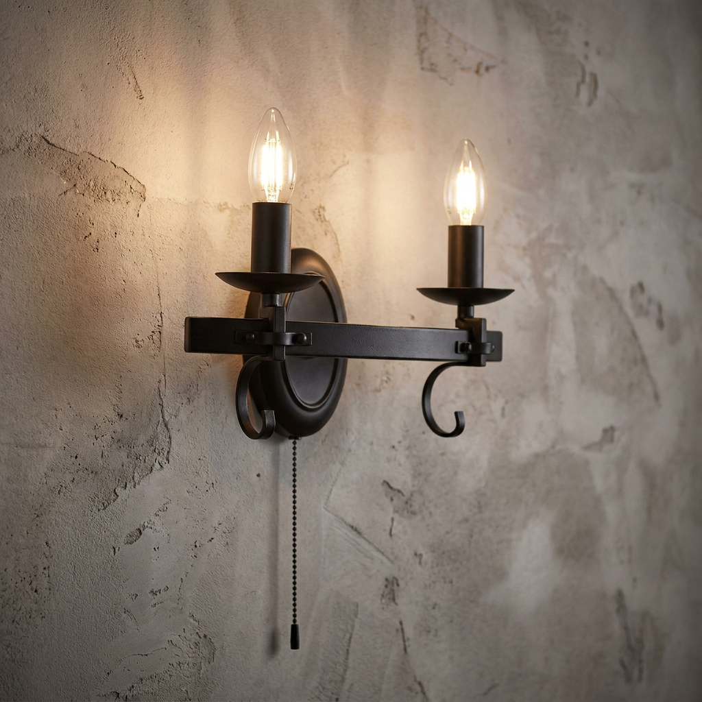 Black wrought iron twin wall light with candle-style bulbs and a pull cord against a textured wall.