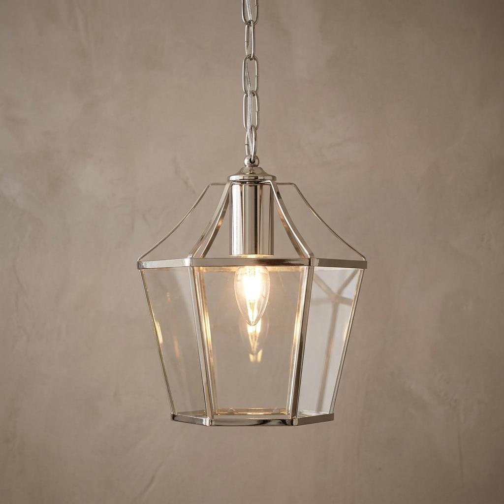 Dulverton antique chrome ceiling lantern with clear glass panels hanging from a chain against a neutral wall.
