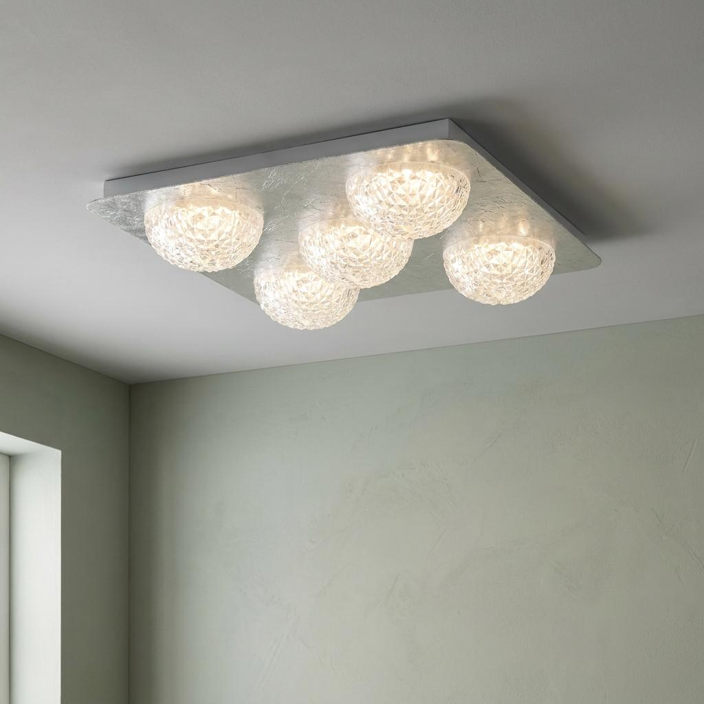 Five glowing faceted acrylic globes on a rectangular silver leaf plate, flush-mounted to a ceiling.