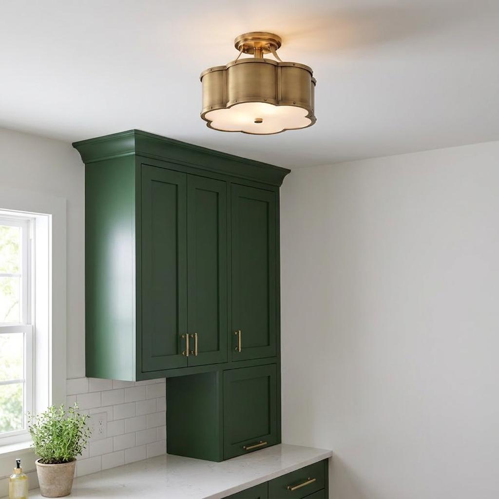Scalloped brass semi-flush ceiling light installed above green kitchen cabinets in a bright room.