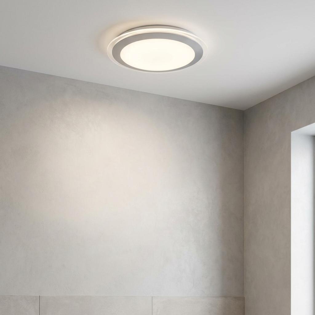 Circular Chester Bathroom LED ceiling flush light with white acrylic shade and grey trim, glowing in a modern room.