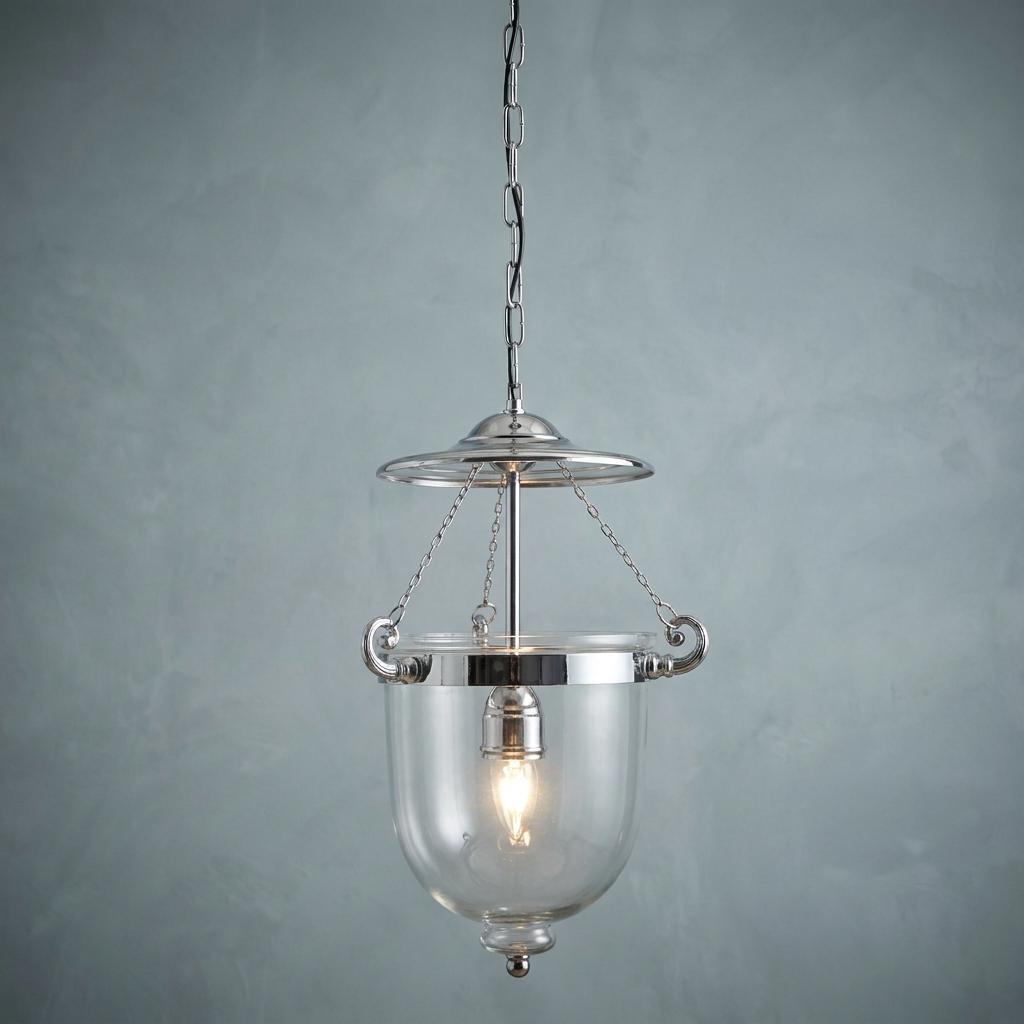 Chrome Georgian ceiling lantern with a clear glass bell shade hanging against a textured grey wall.