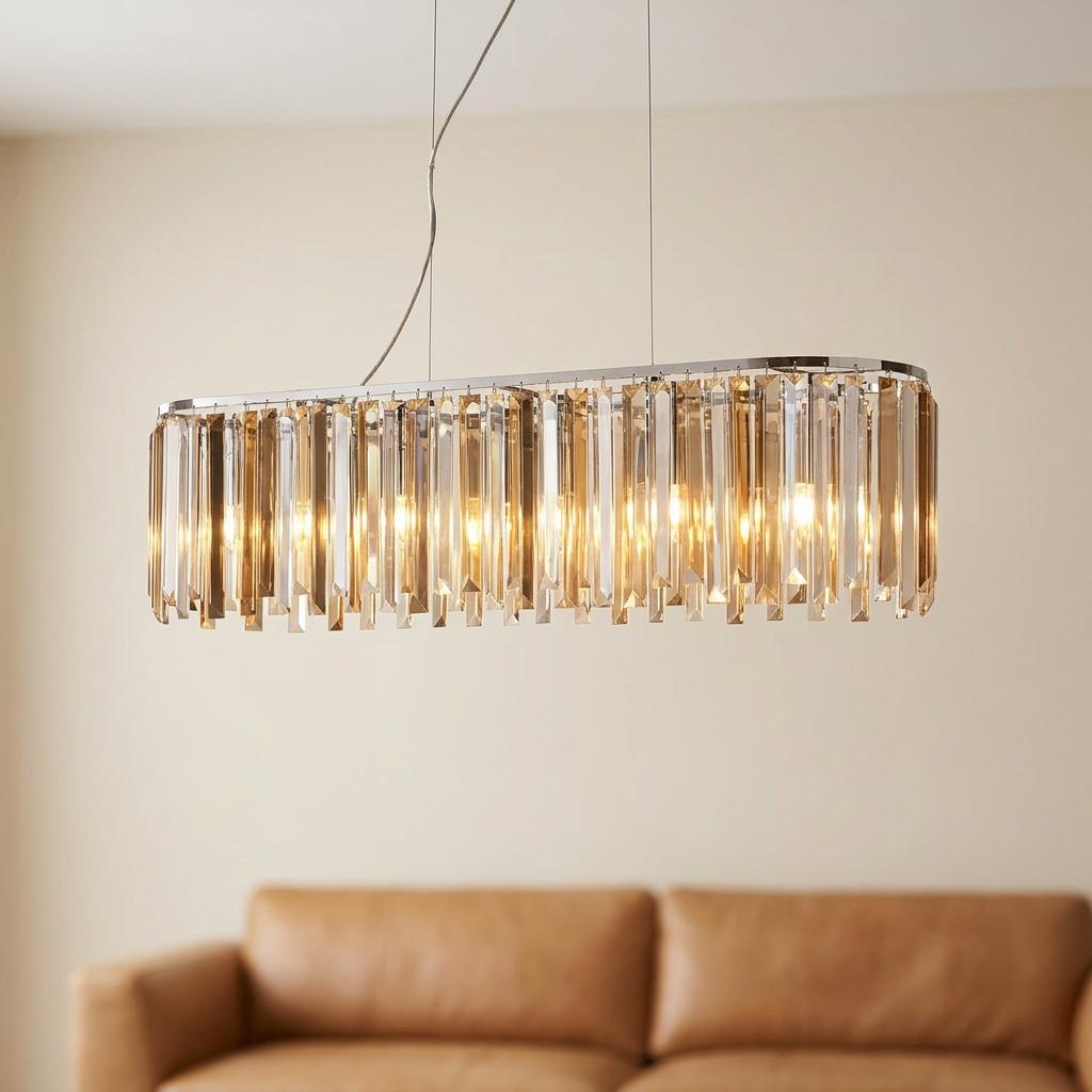 Clarissa 8 light chrome ceiling pendant bar with crystal drops hanging above a tan leather sofa.