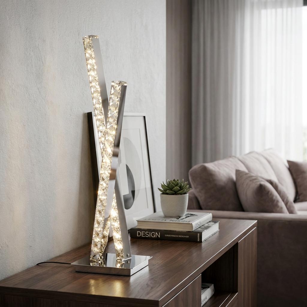 A modern chrome table lamp with two intersecting crystal-filled LED bars on a wooden side table in a living room.