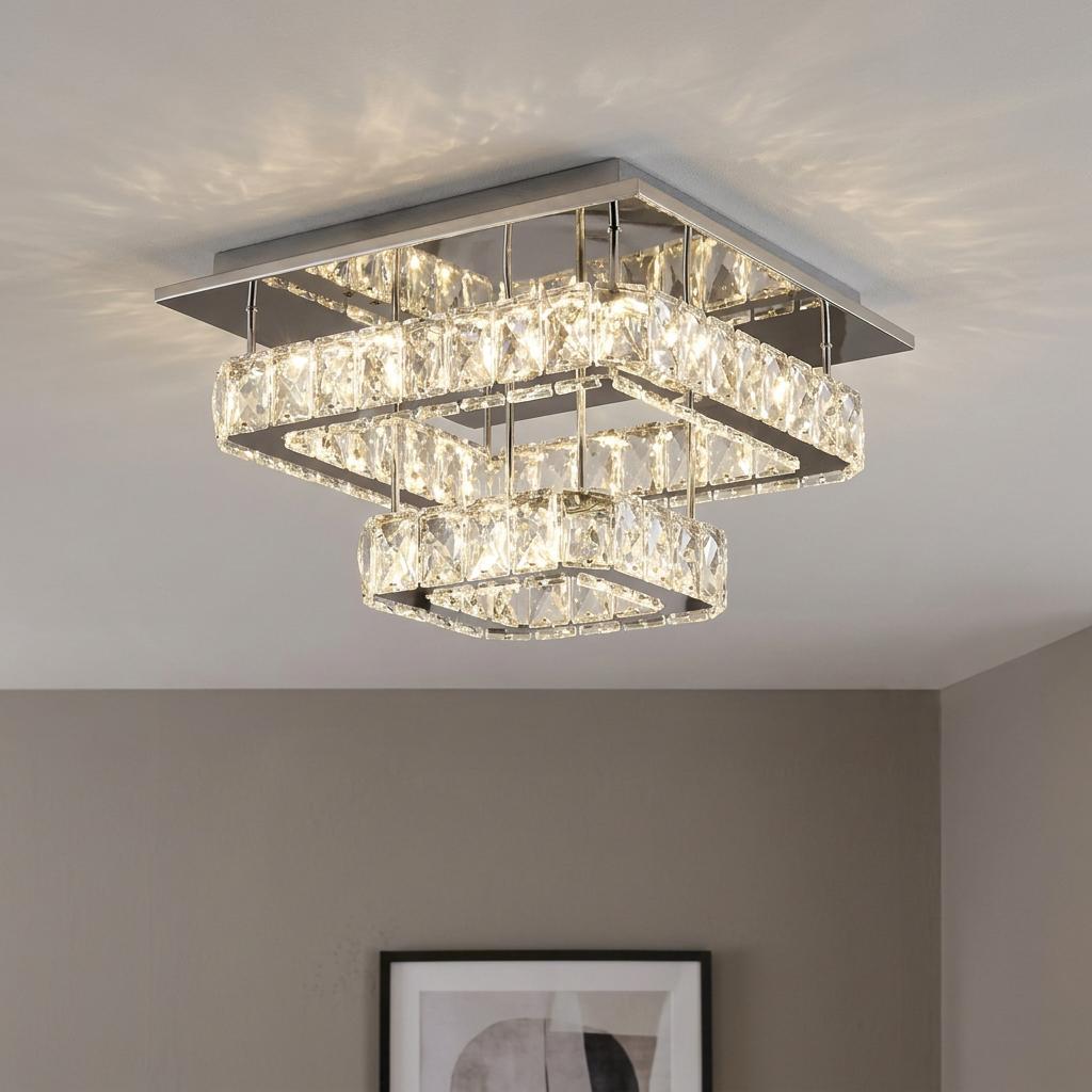 Two-tier square chrome ceiling light with clear crystal panels, illuminated and casting light on the ceiling.