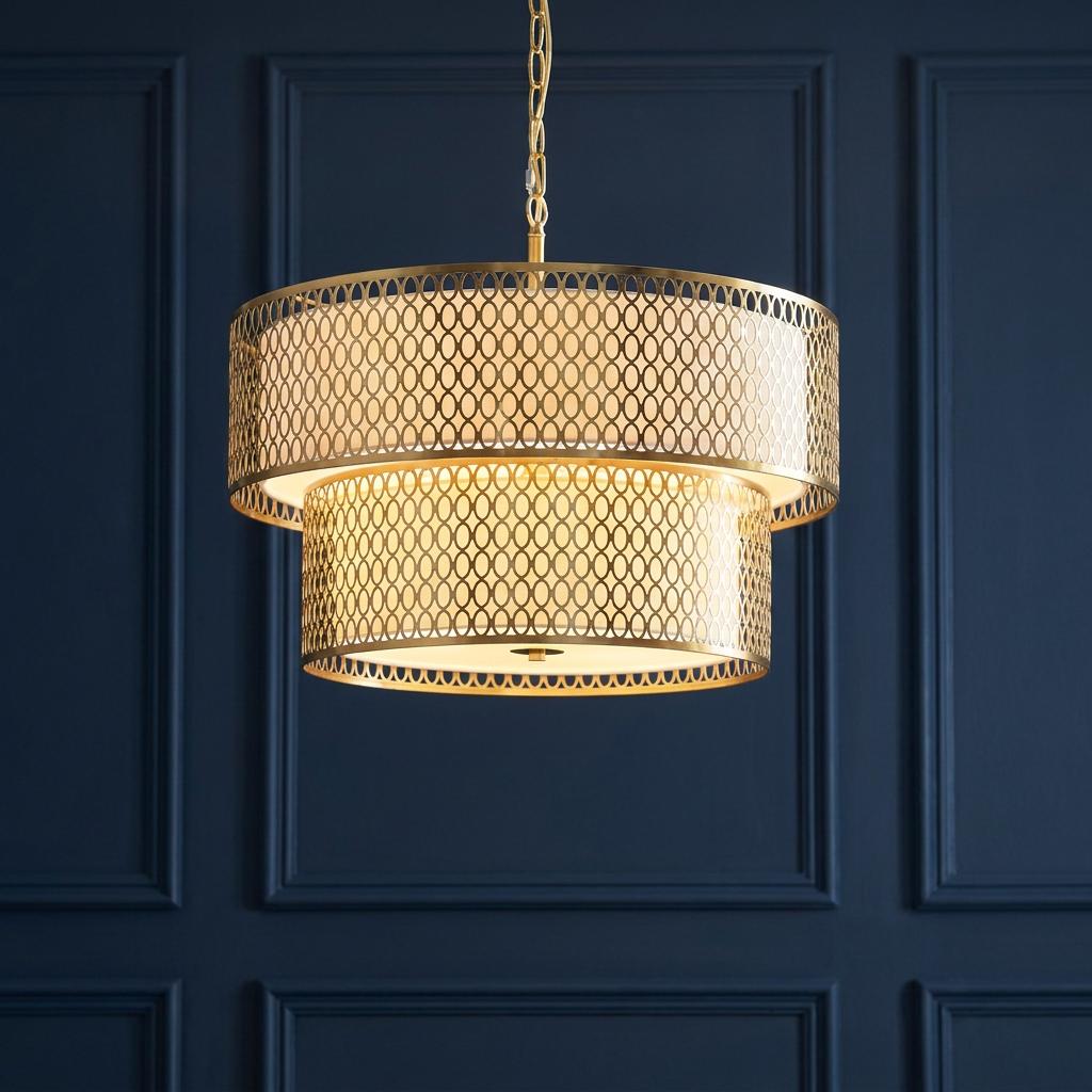 A two-tiered gold pendant light with a lattice pattern glowing against a dark blue paneled wall.