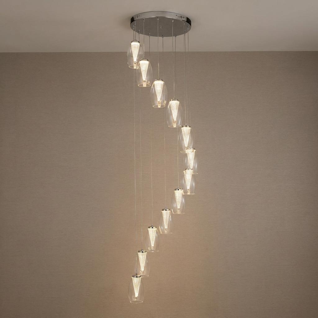 Cyclone 12-light LED multi-drop pendant with glass shades cascading in a spiral against a neutral wall.