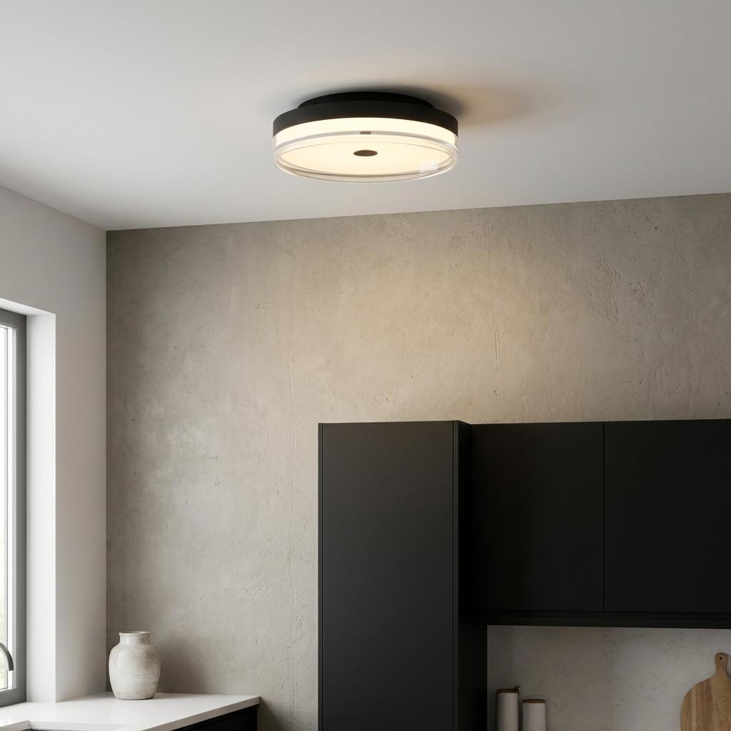 Modern black flush ceiling light with illuminated glass rings above minimalist black kitchen cabinetry.