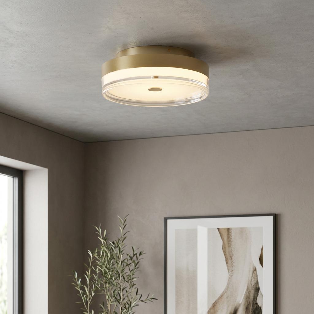 Modern Cyprus gold flush ceiling light with a tiered clear shade mounted on a grey concrete-effect ceiling.