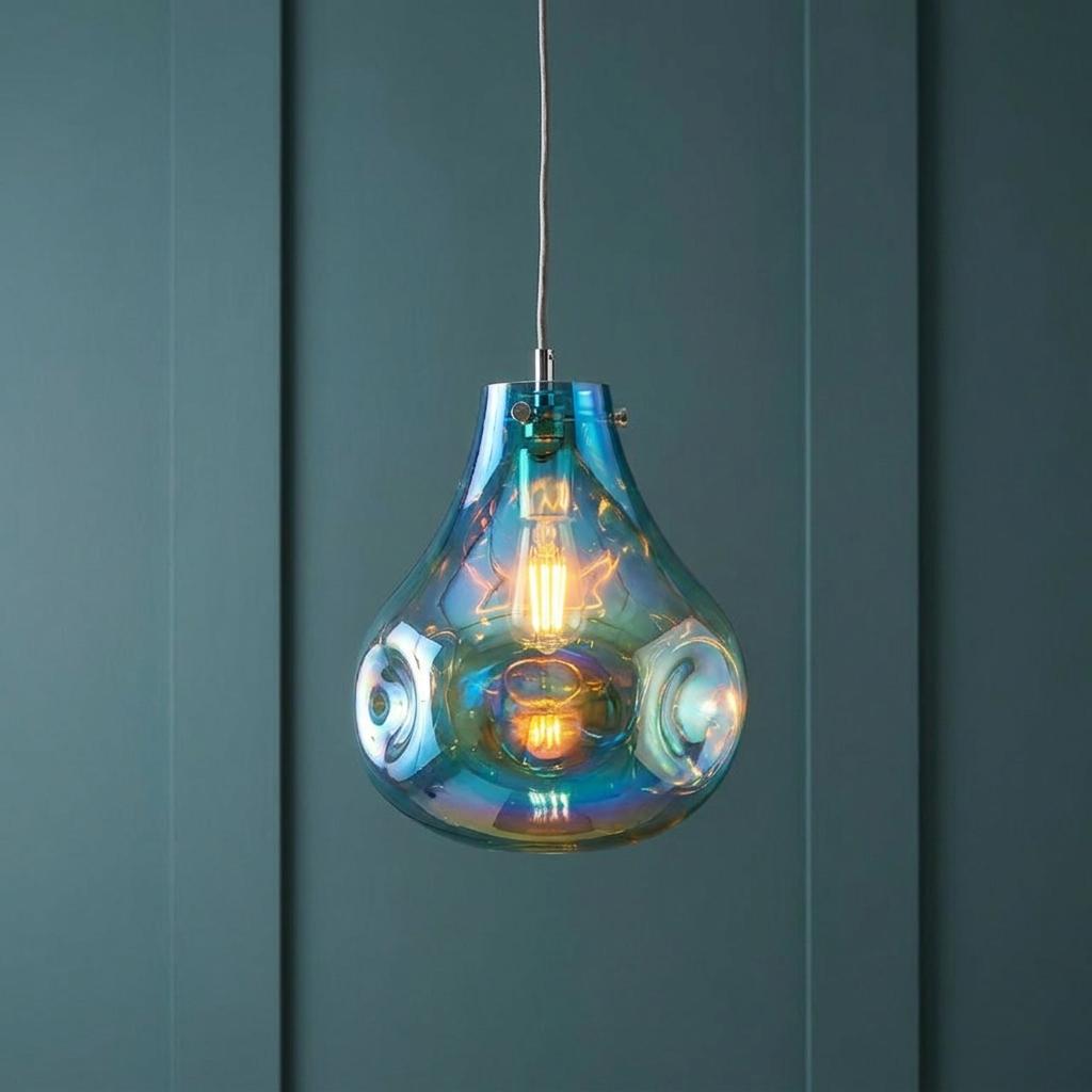 Dazzle Large Blown Petrol Glass & Chrome Pendant Light with an iridescent finish against a blue paneled wall.