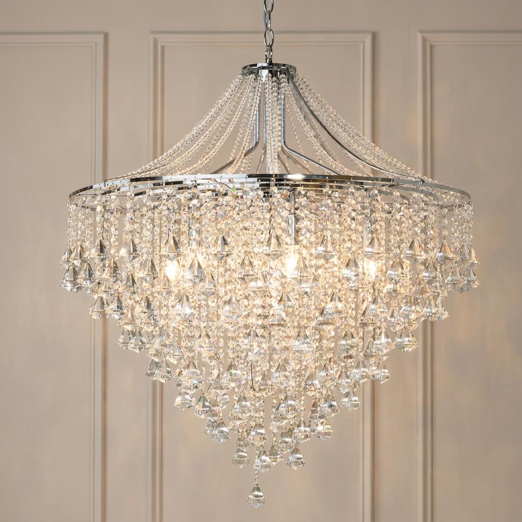 Dorchester 7-light chrome and crystal pendant chandelier with cascading droplets against a paneled wall.