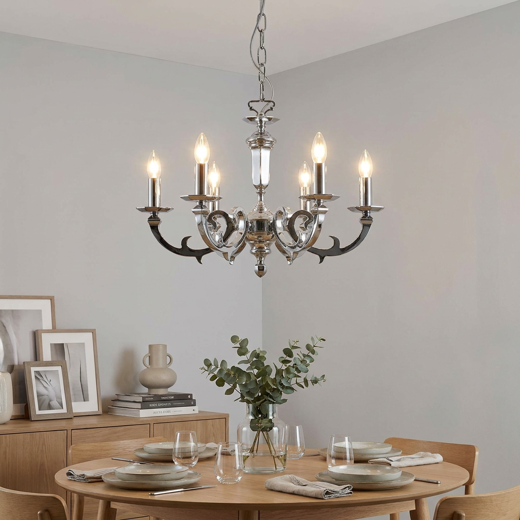 A Dorchester 6-light chrome chandelier hangs over a modern dining table set with eucalyptus and neutral tableware.