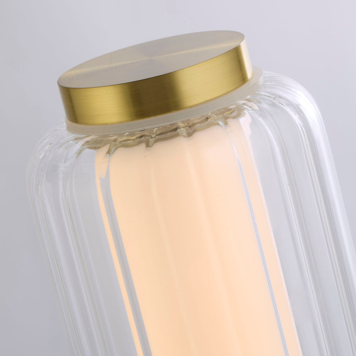 Detail of the Mod brushed brass cap ribbed clear glass and inner opal LED tube