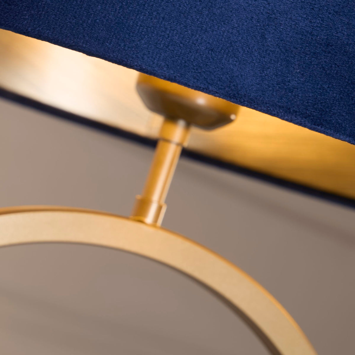 Close-up of the brushed bronze ring and holder beneath the Elegant navy velvet shade