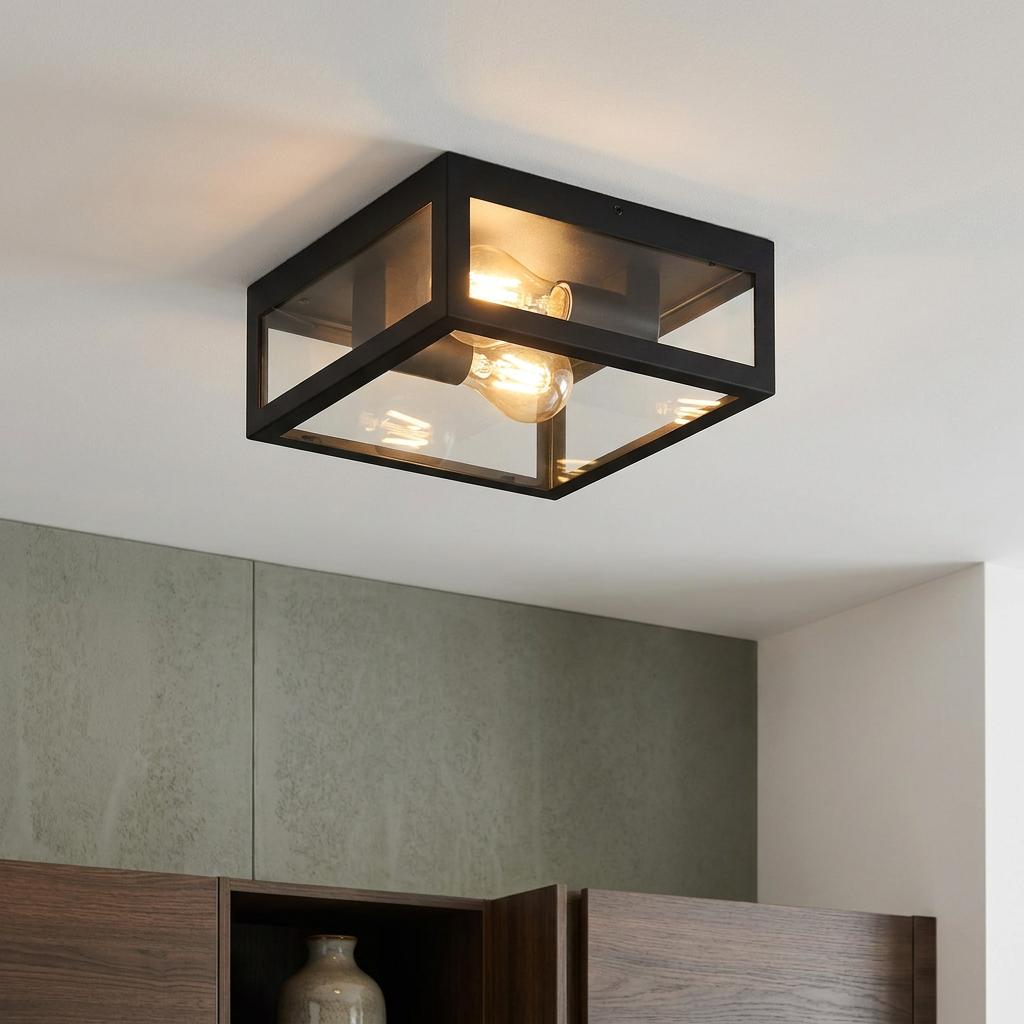 Eglo Amezola black square flush ceiling light with two lit filament bulbs behind clear glass panels.