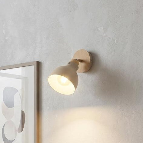 Eglo Arrecife wall spotlight in sandy beige and wood illuminating a cozy living room with a neutral armchair.