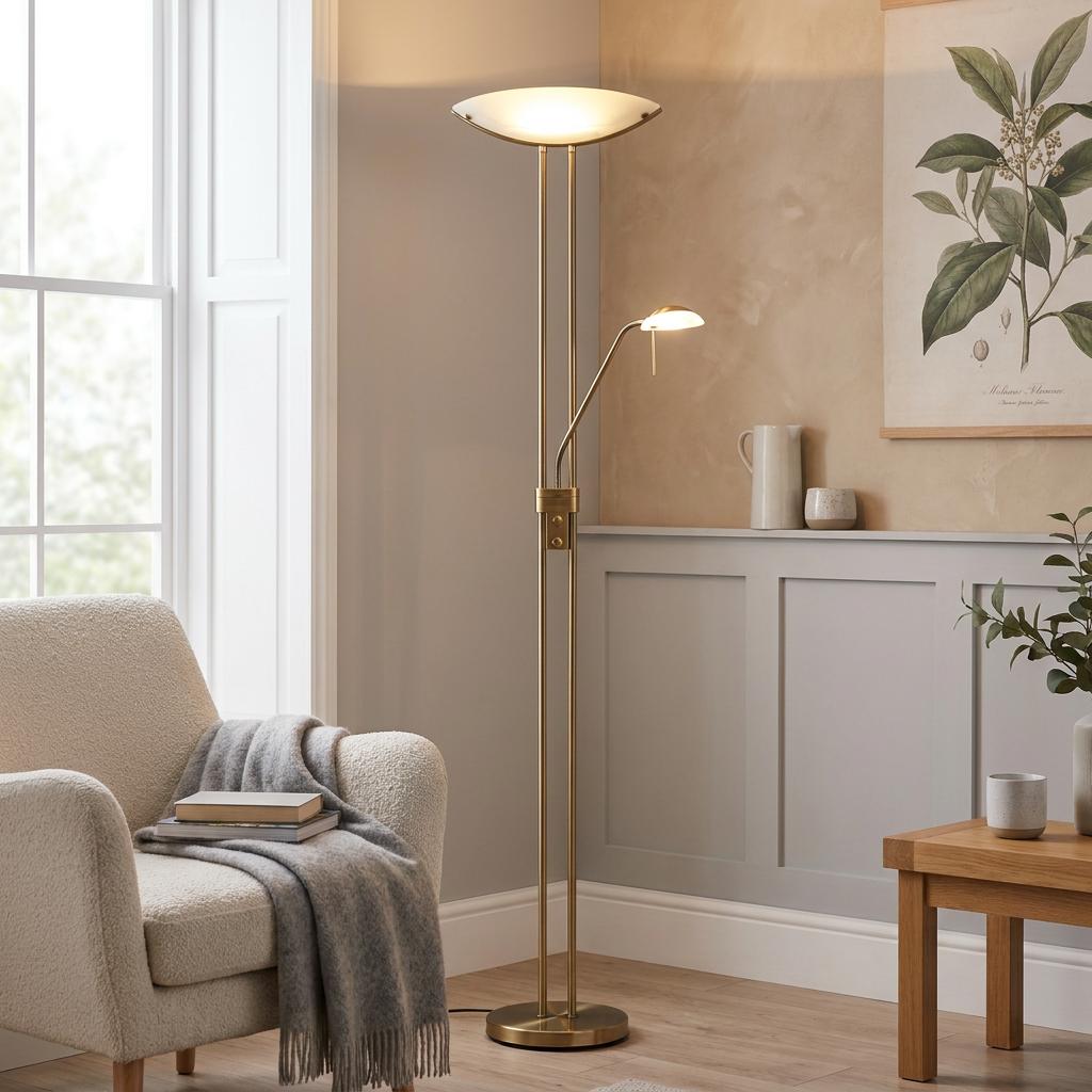 Bronze mother and child floor lamp next to a cream armchair in a warmly lit, neutral-toned living room.