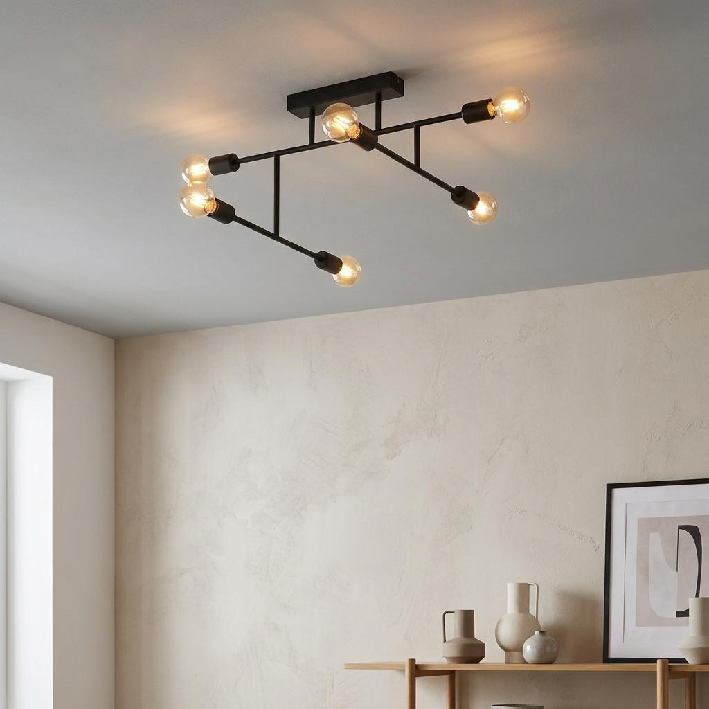 A 6-light black industrial flush ceiling light with warm glowing bulbs in a minimalist room.