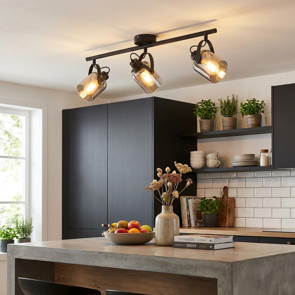 Eglo Berregas three-light bar spotlight with vaporised glass shades illuminated over a modern kitchen island.