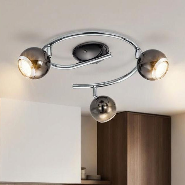 Eglo Bimeda three-light spiral ceiling spotlight in black nickel and chrome finish over a modern kitchen island.