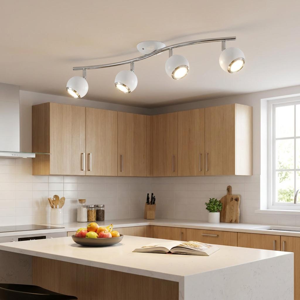 White and chrome 4-light curved bar spotlight illuminating a modern kitchen with wooden cabinets and island.