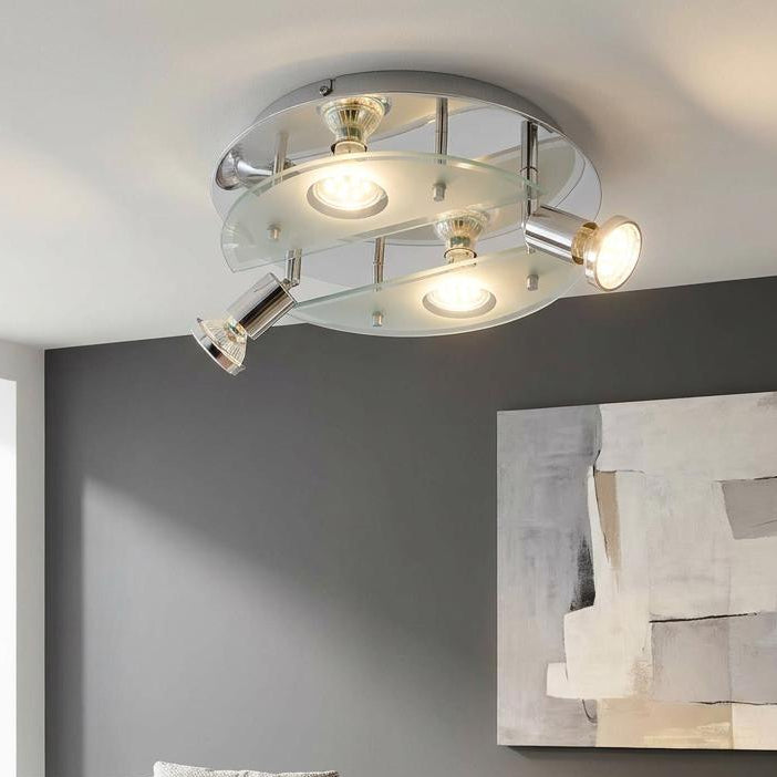 Eglo Cabo 1 chrome and glass 4-light ceiling fixture in a contemporary living room with a grey sofa and art.
