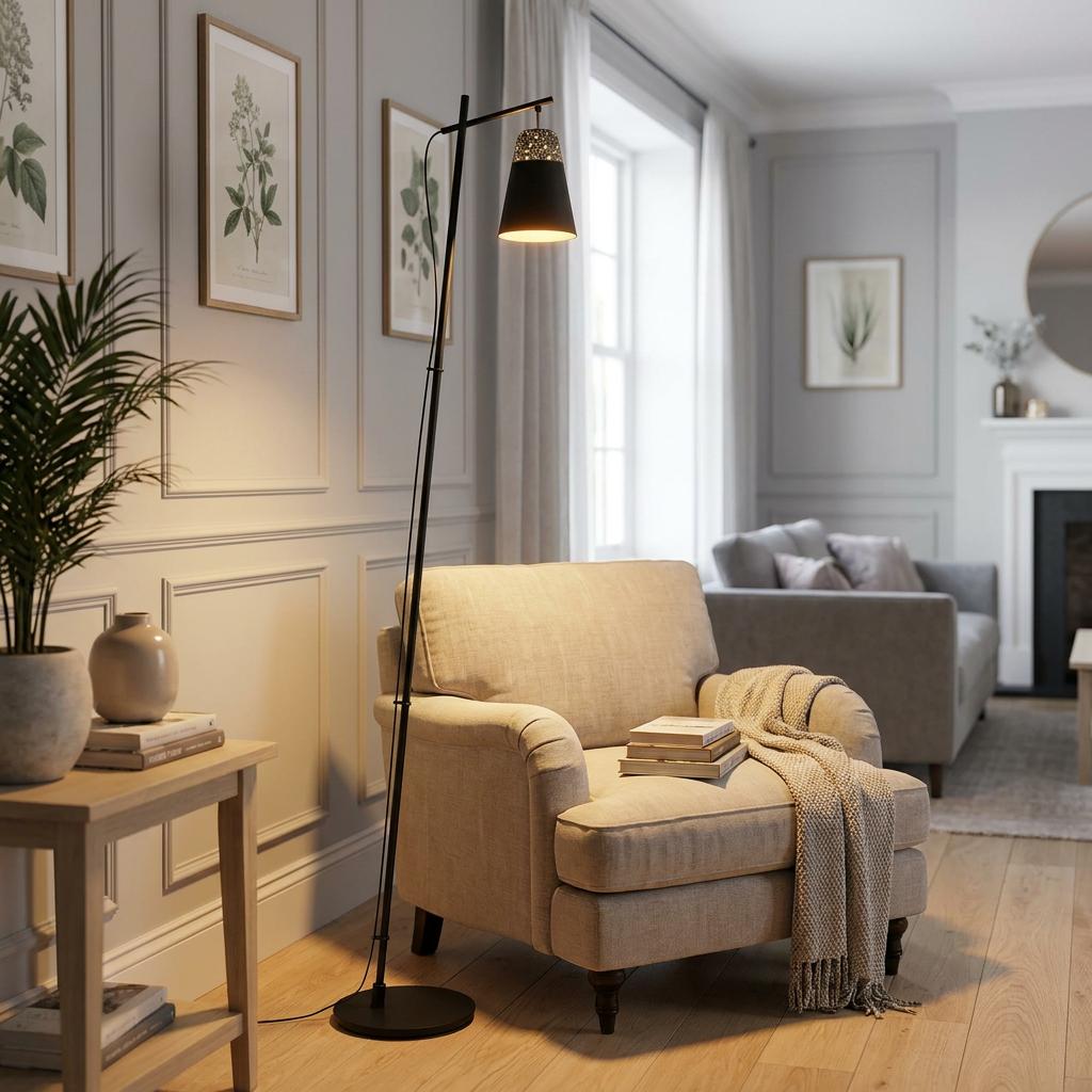 Black floor lamp with a conical metal shade illuminates a beige armchair in a modern living room setting.