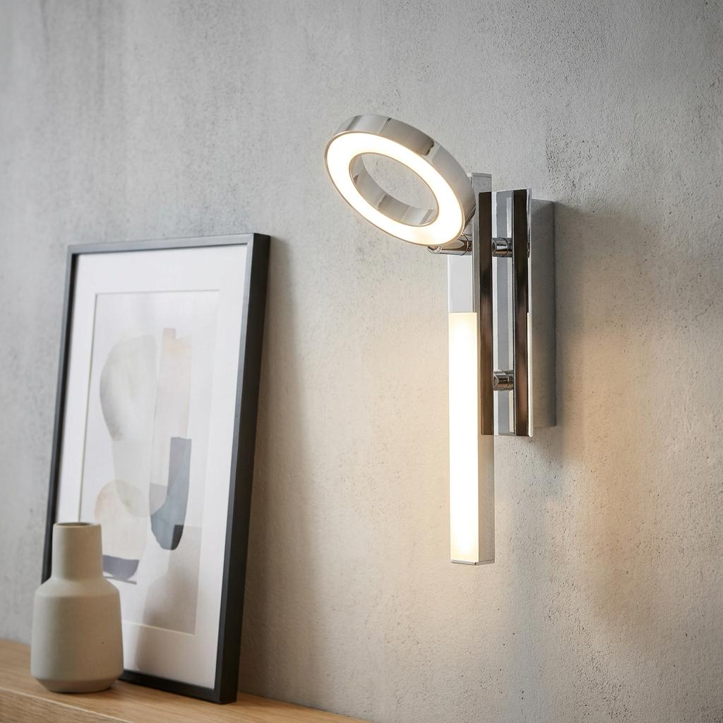 Eglo Cardillio 1 chrome wall spotlight with an illuminated LED ring and linear bar mounted on a textured grey wall.