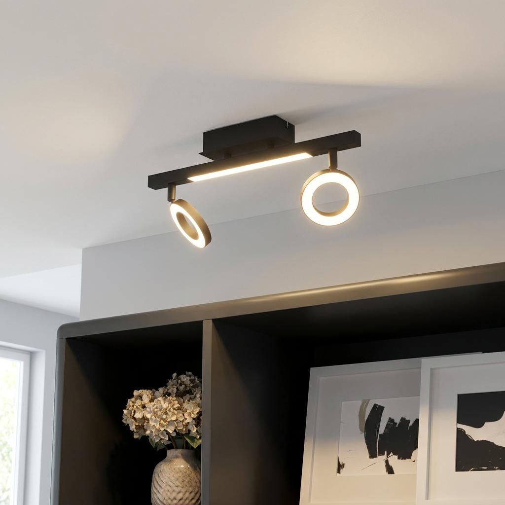 Modern black Eglo Cardillio 2 LED ceiling light with two ring spotlights and a central bar illuminating a dark shelf.