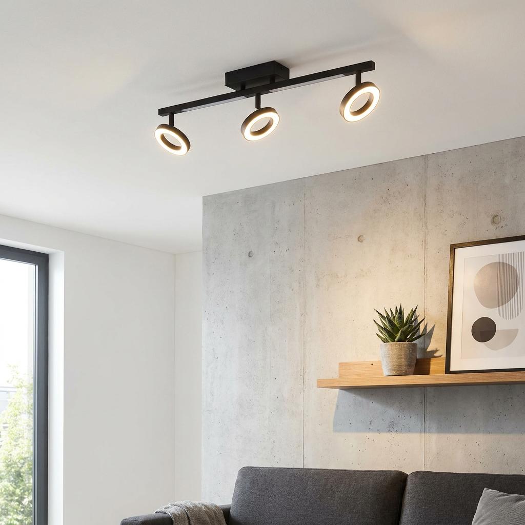 Eglo Cardillio 2 black 3-light bar spotlight with circular LED heads on a modern living room ceiling.