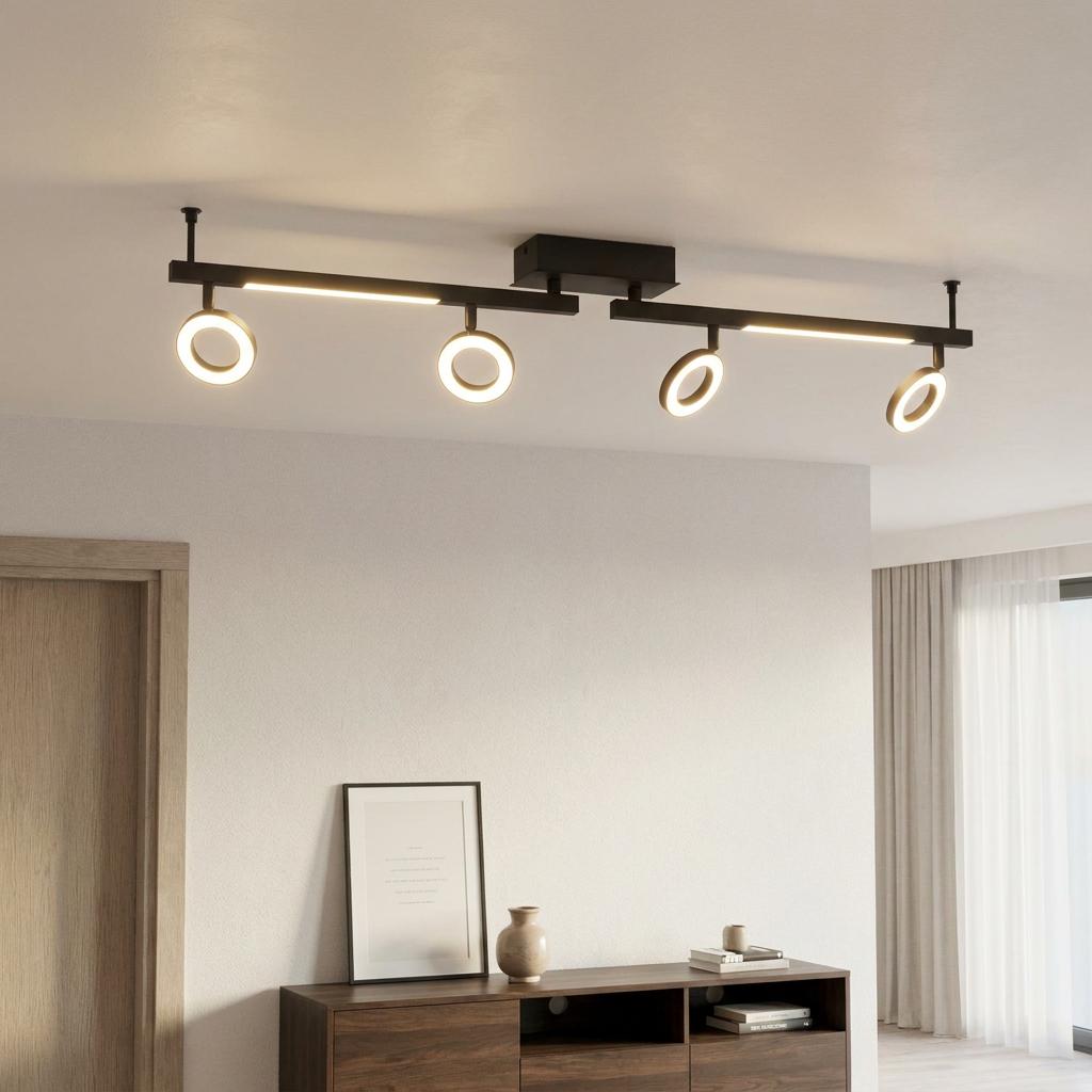 Black Eglo Cardillio 2 LED track light with four illuminated ring heads on a ceiling above a wooden sideboard.