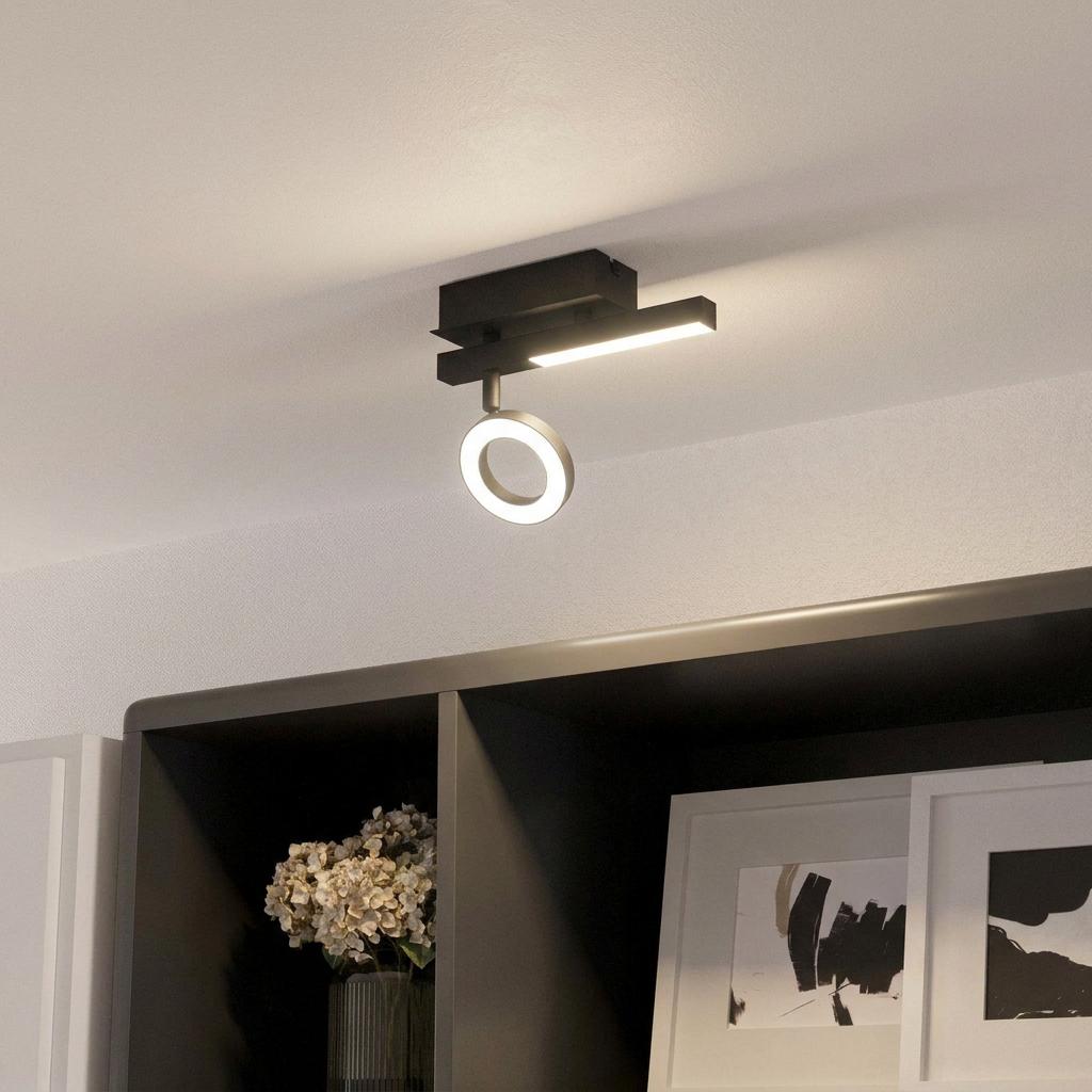 Black Eglo Cardillio 2 LED spotlight with ring and bar elements mounted on a ceiling above a shelf.