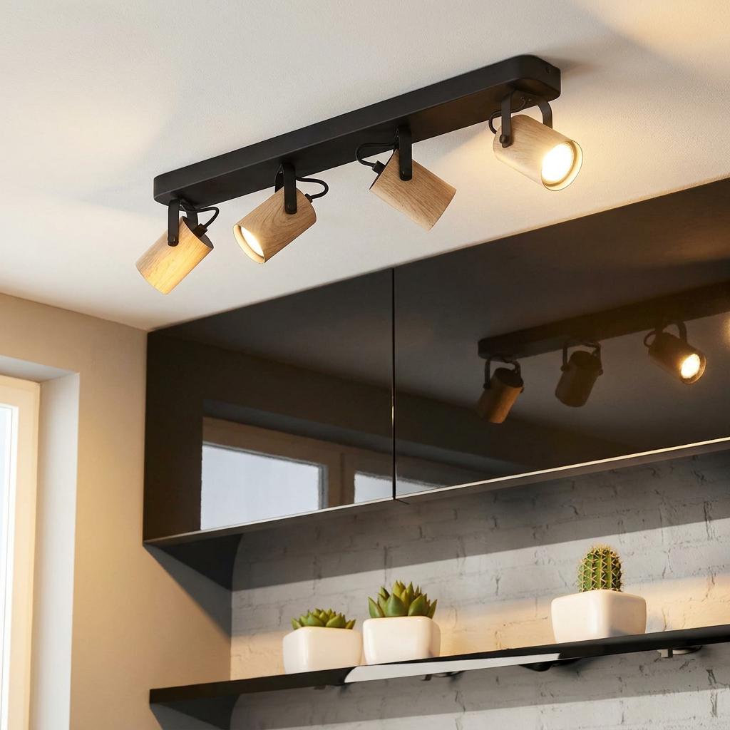 Eglo Cayuca 4-light bar spotlight with wooden shades and black metal mount fixed to a ceiling.