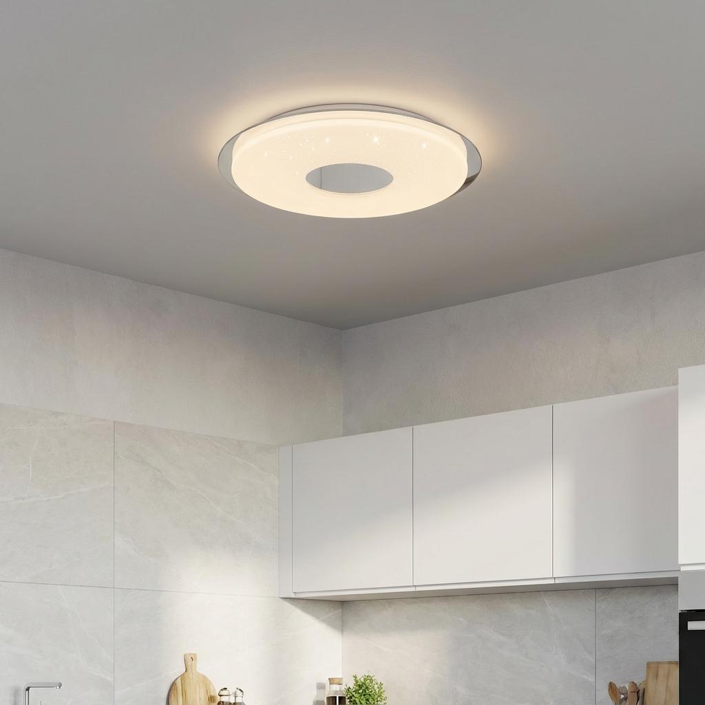 Modern donut-shaped sparkling LED ceiling flush light with chrome accents mounted in a contemporary kitchen.