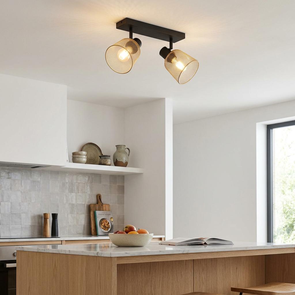 Two-light ceiling bar spotlight with brass mesh shades and a black base installed in a contemporary kitchen.