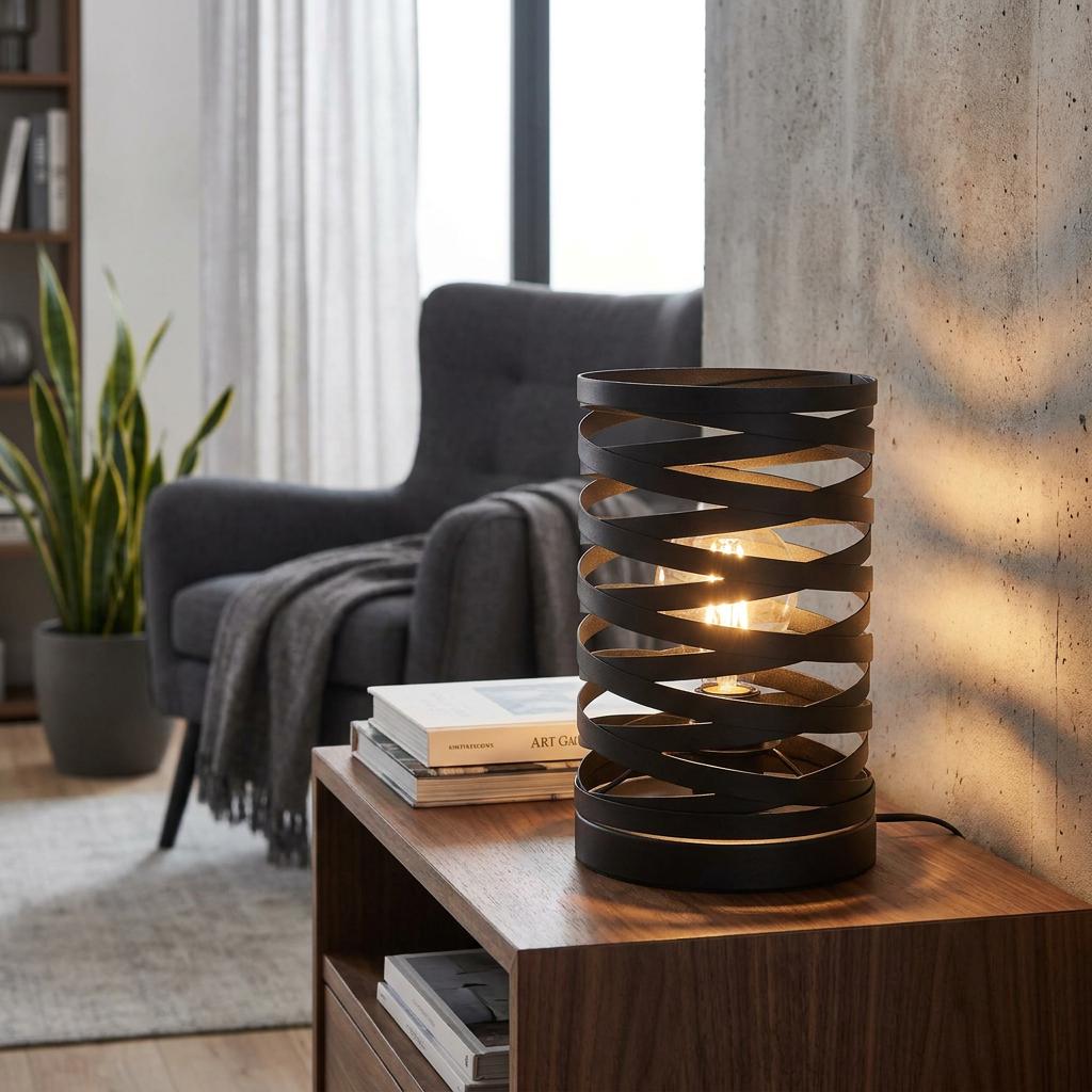 Black metal spiral table lamp with a glowing bulb on a wooden side table in a modern living room setting.