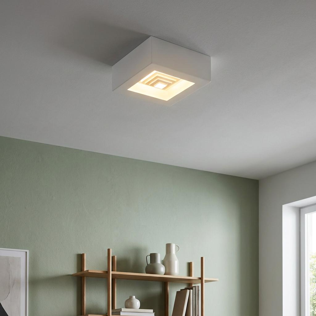 Eglo Ferreros square white LED ceiling light glowing in a minimalist room with green walls and wooden shelves.