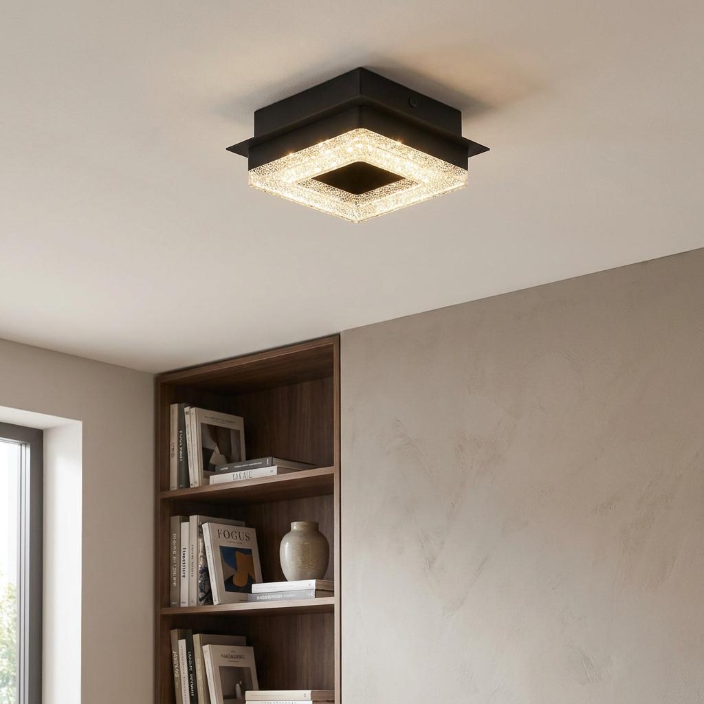 Square black flush ceiling light with a glowing crystal-effect frame, mounted in a contemporary room.