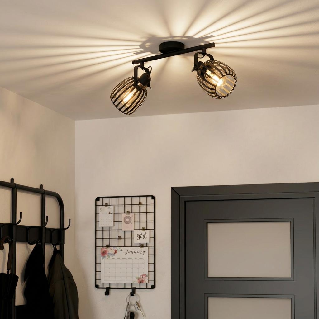 Eglo Girona 2-light bar spotlight with black cage shades casting dramatic radial shadows on a white ceiling.