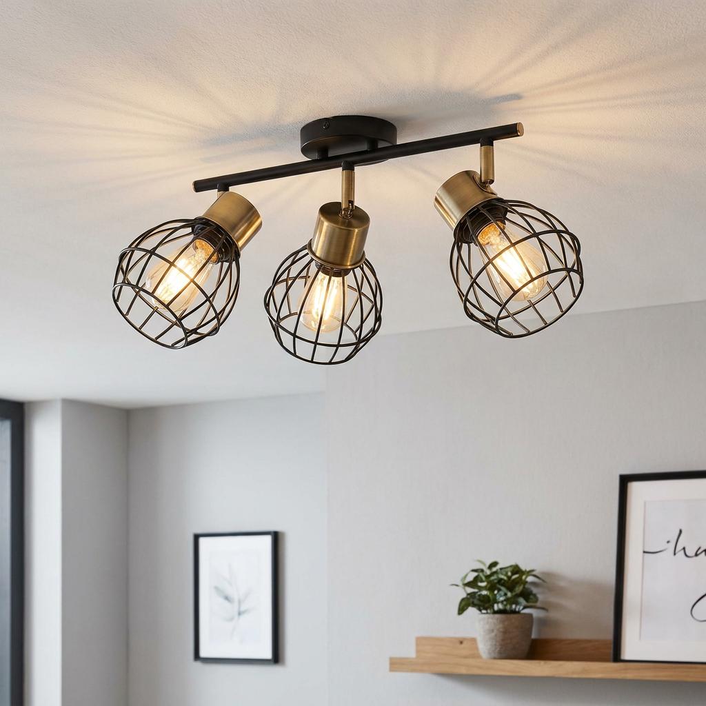 Eglo Girona three-light bar spotlight with black wire cage shades and brass accents mounted on a ceiling.