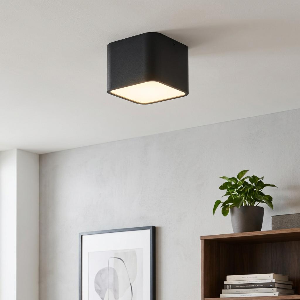 Eglo Grimasola black square flush ceiling light illuminated in a modern living room setting.