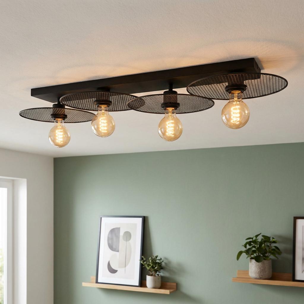 Eglo Ikeston 4-light black mesh flush ceiling light with Edison bulbs in a room with a green wall.