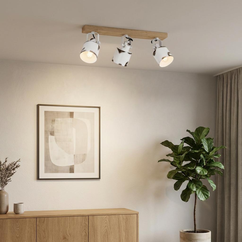Eglo Kilburn three-light bar spotlight with distressed white shades on a wooden base in a modern living room setting.