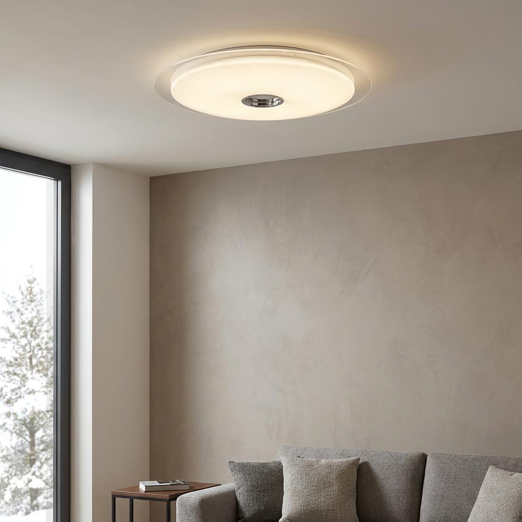 Large round white LED flush ceiling light with sparkle effect illuminated in a modern living room.