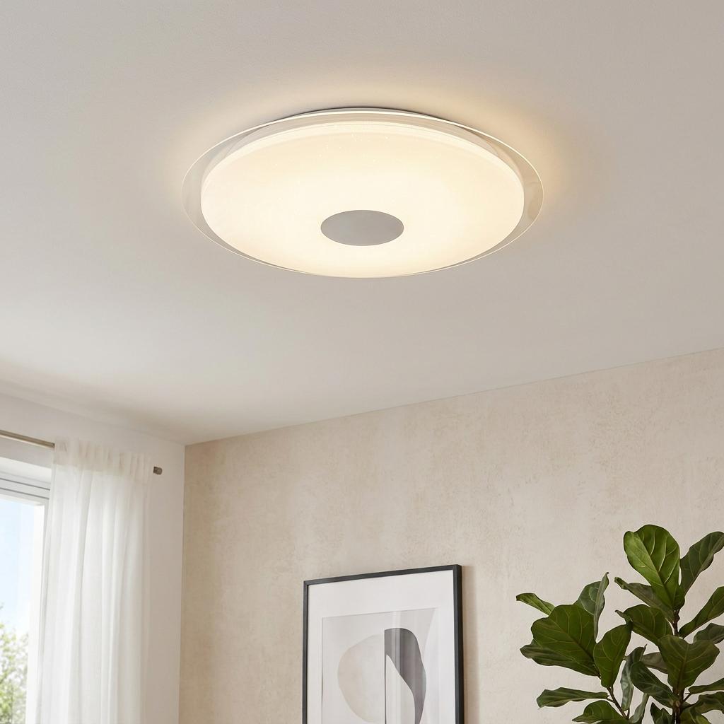 Round flush LED ceiling light with a sparkling crystal effect and a central silver hub, mounted on a white ceiling.